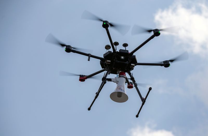 Rwandan police drone fitted with megaphone speaker flies in neighbourhood