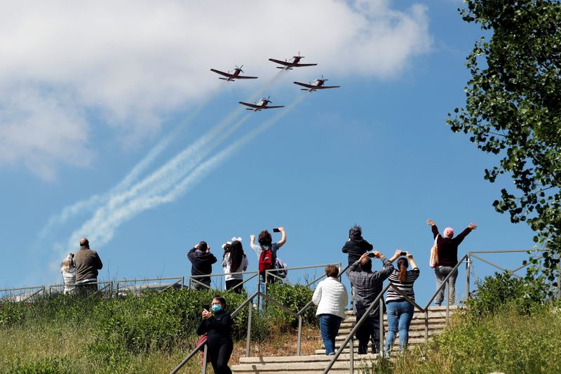 People watch as Israeli Air Force planes fly in formation