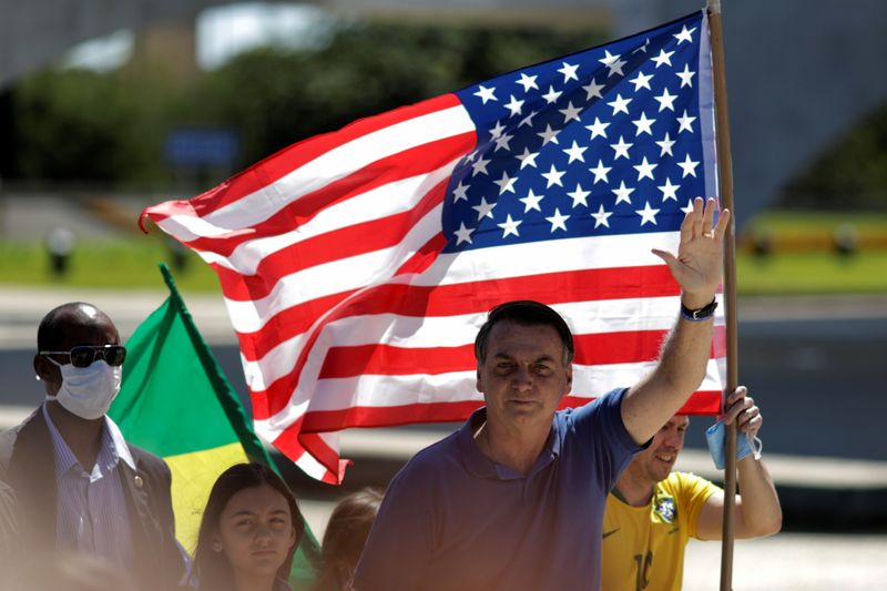 Brazil’s President Jair Bolsonaro greets supporters during a protest, in