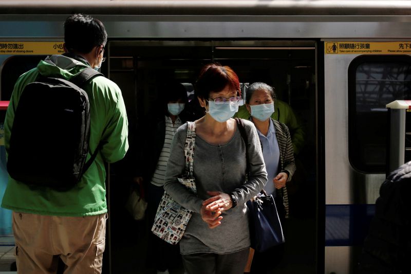 People wear face masks as a mandatory precaution for riding