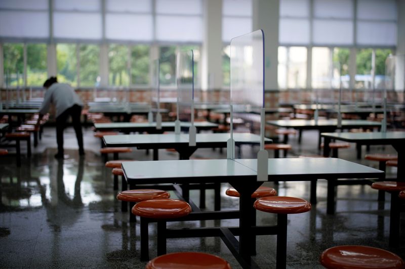 Worker is seen inside a canteen with partitions on the