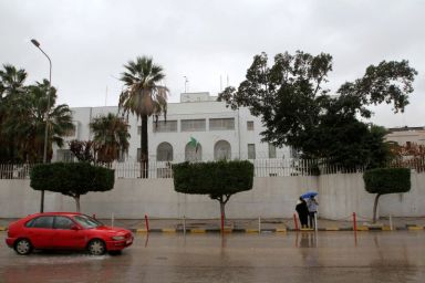 FILE PHOTO: Car drives past the Italian embassy in Tripoli