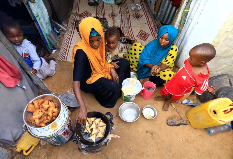 An internally displaced Somali woman and her children prepare their