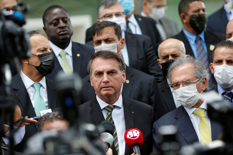 Brazil’s President Jair Bolsonaro speaks with journalists after a meeting