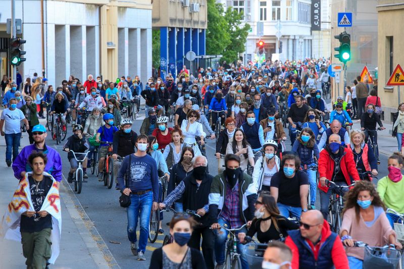 Protesters ride bicycles during an anti-government protest in Ljubljana