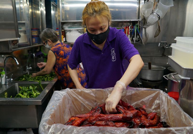 Hawker Kristen Choong prepares ingredients with her mother Lai Yau