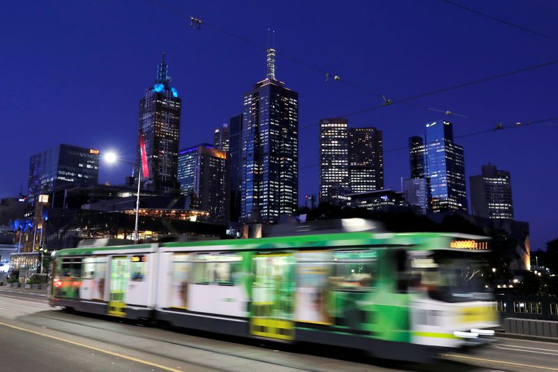 The city skyline is seen as a tram crosses the