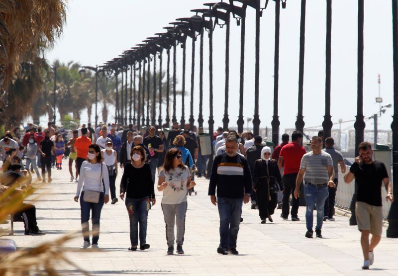 People walk along Beirut’s seaside Corniche, as Lebanese authorities warned