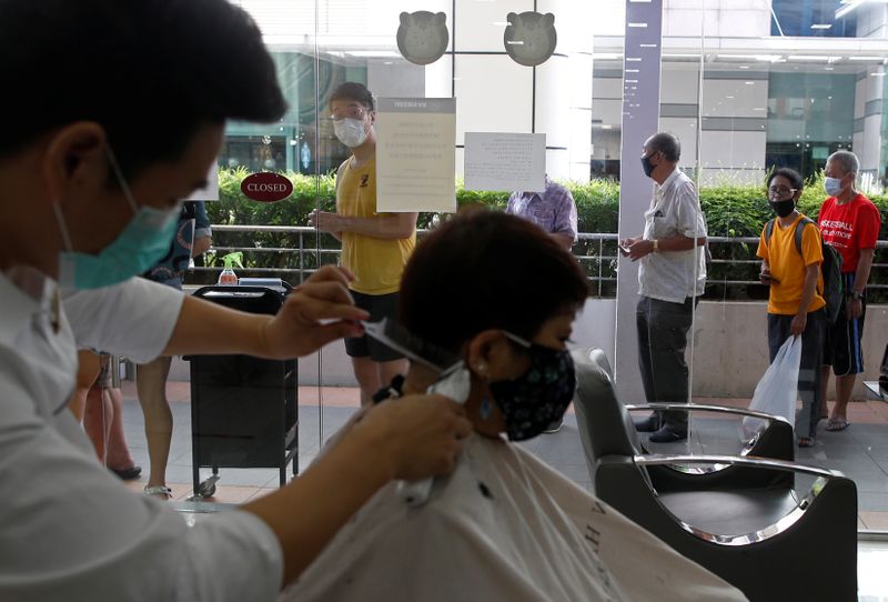 Customers queue up to have their haircut outside a hairdressing