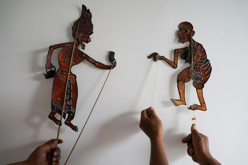 Cambodian puppet artists display some of their shadow puppets at
