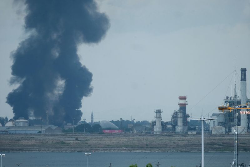 Large clouds of black smoke billows from a chemical plant