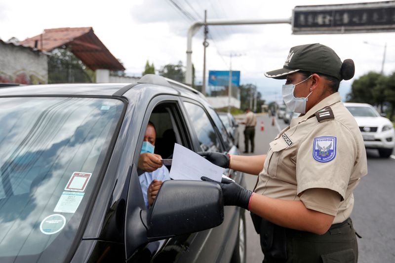 FILE PHOTO: An Ecuadoran police officer checks a driver’s safe