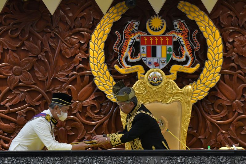 Malaysia’s King Sultan Abdullah Sultan Ahmad Shah receives documents from