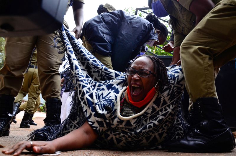 Ugandan academic Stella Nyanzi reacts as police officers detain her