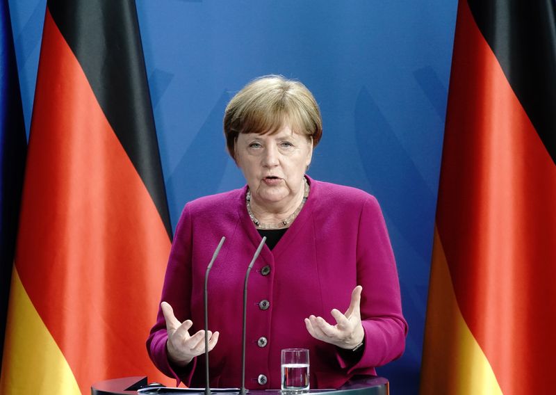 FILE PHOTO:  German Chancellor Angela Merkel holds a joint