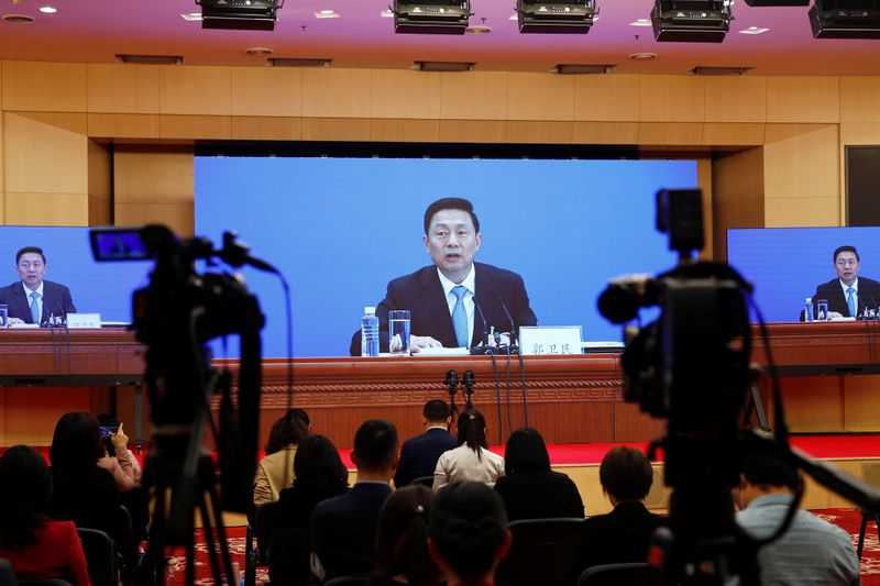 Journalists attend a news conference by Guo Weimin in Beijing