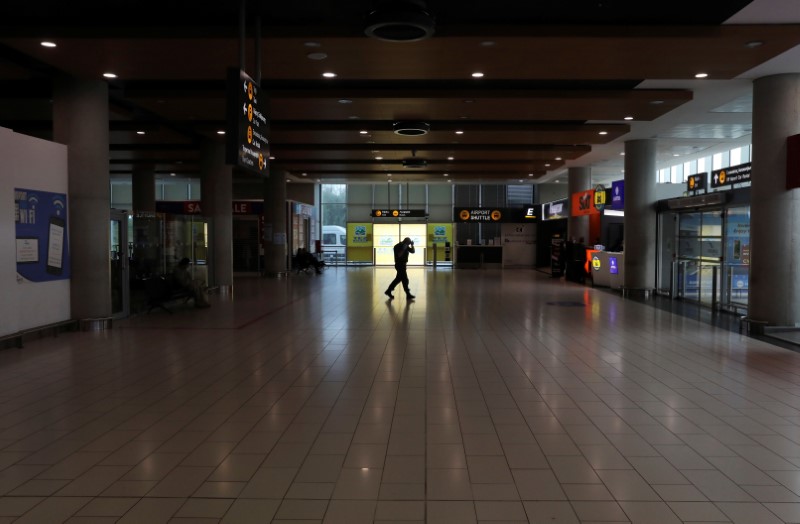 FILE PHOTO:  A man walks in an almost empty