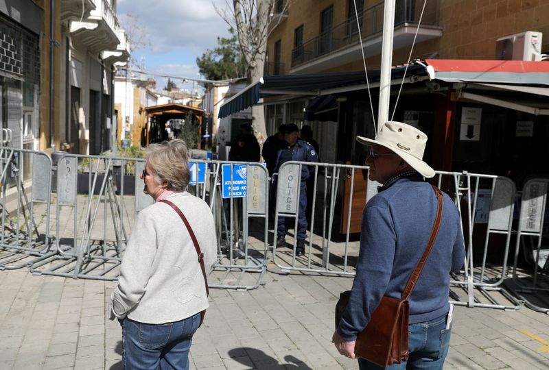 FILE PHOTO: Tourists walks near the closed Ledra checkpoint after