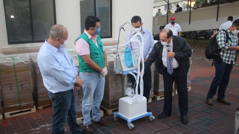 Bolivia’s Health Minister Marcelo Navajas looks at a ventilator in