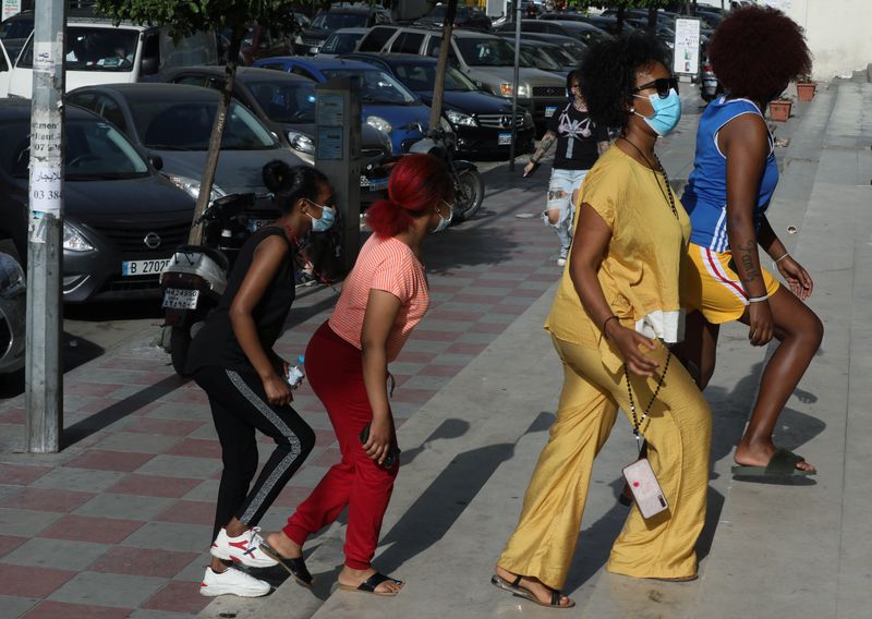 Women walk along a street in Dora