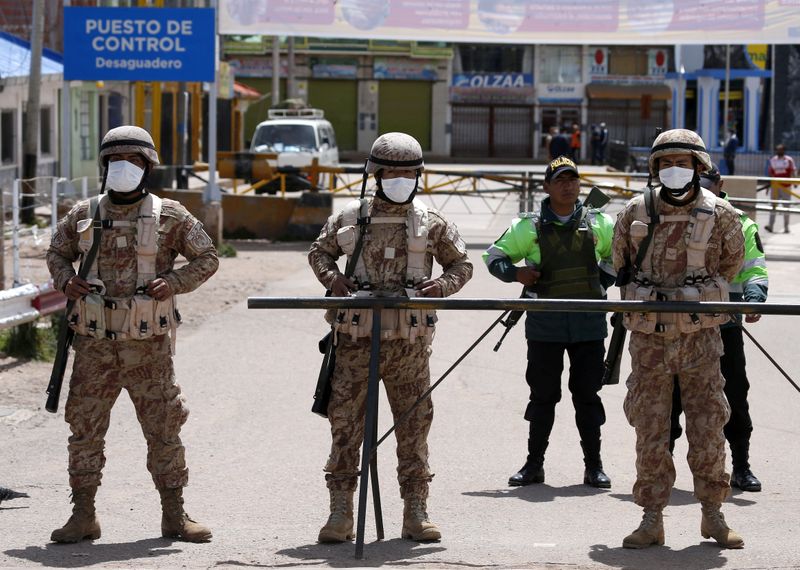 FILE PHOTO: Peruvian soldiers stand at the border between Peru