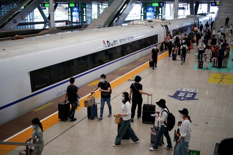 People wearing face masks are seen at Wuhan Railway Station,