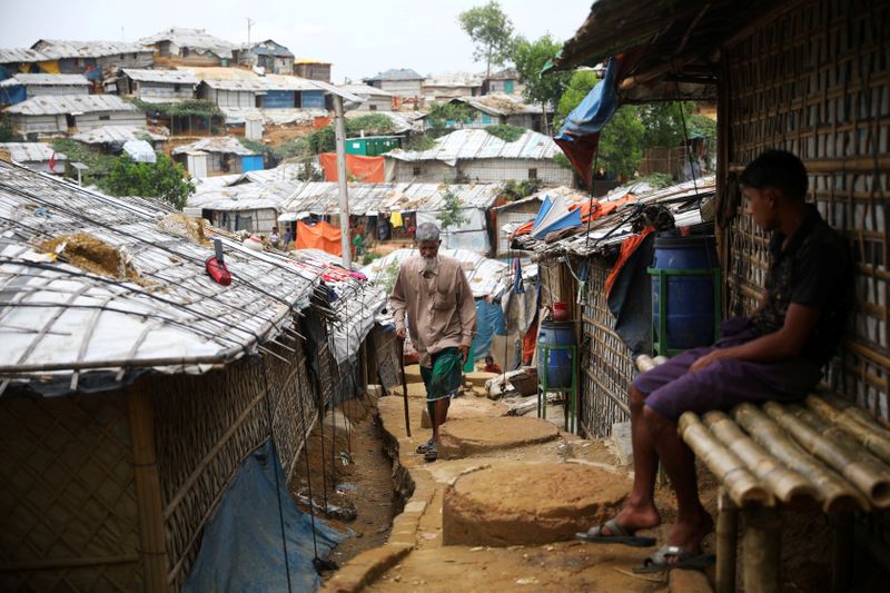 FILE PHOTO: A Rohingya refugee walks at a refugee camp