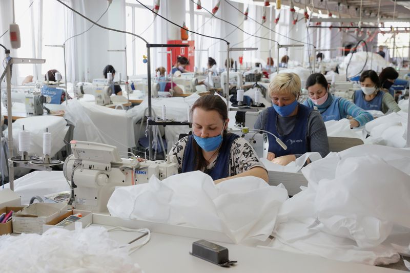 Employees sew protective suits at the Textile-Contact company’s factory in