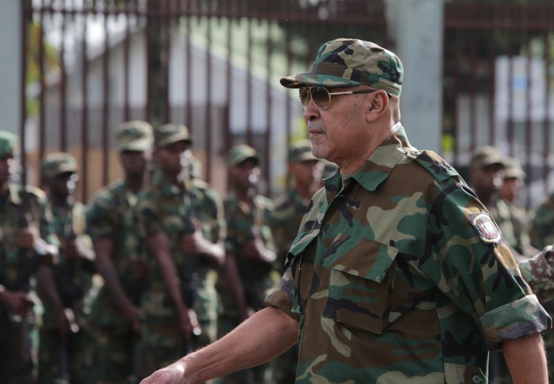 Suriname’s President Desi Bouterse reviews the troops during a ceremony