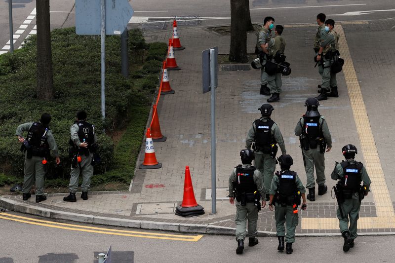 Riot police officers stand guard as a second reading of
