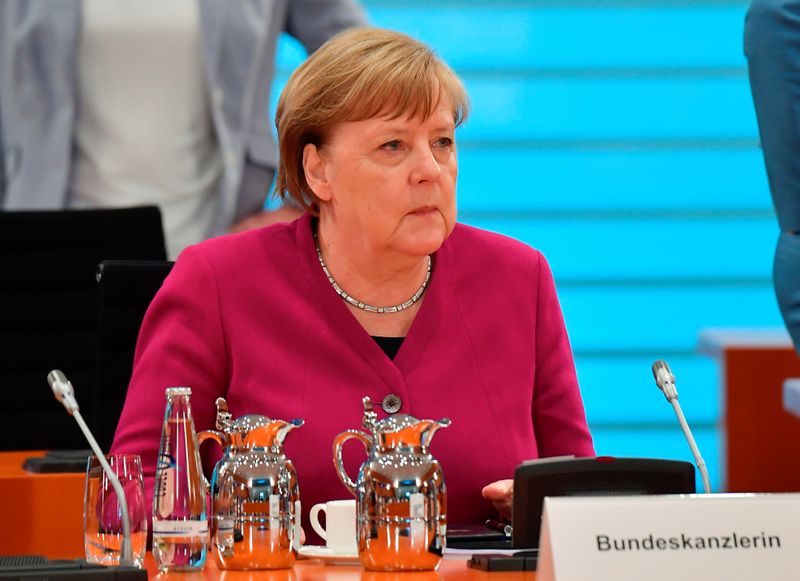 German Chancellor Angela Merkel looks on at the start of