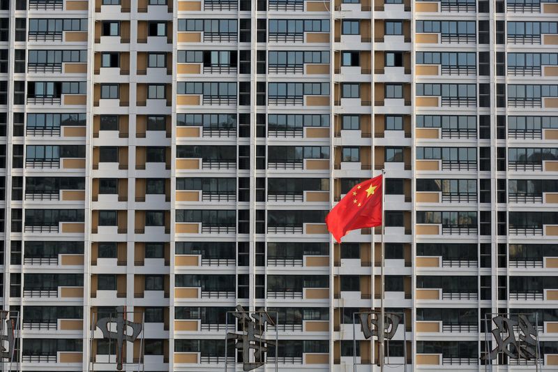 FILE PHOTO: Chinese flag flutters in front of a residential
