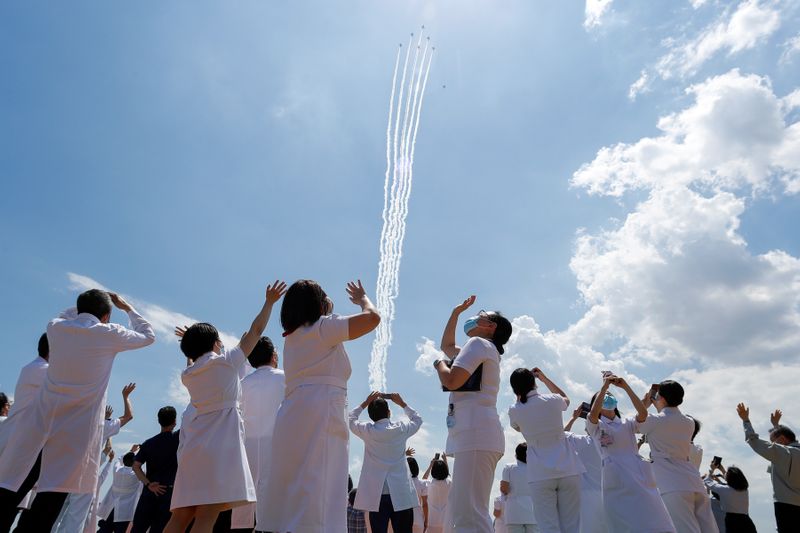 Japan Air Self-Defense Force stages a flyover to salute the