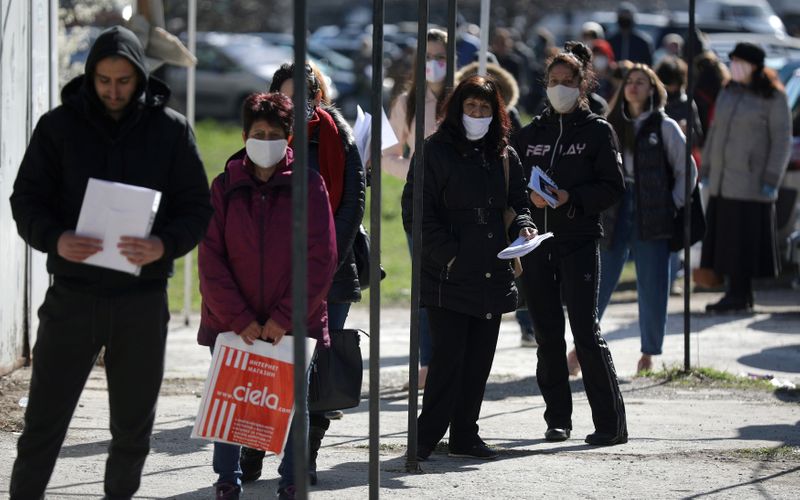 FILE PHOTO: People wearing face masks in attempt to prevent