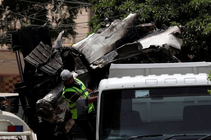 A truck is loaded with the wreckage of the crashed