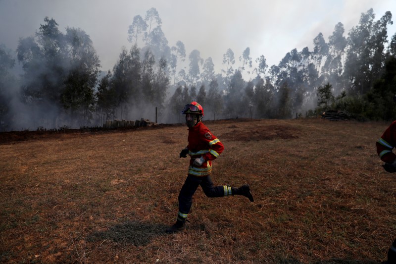 FILE PHOTO: A firefighter runs as he helps to put