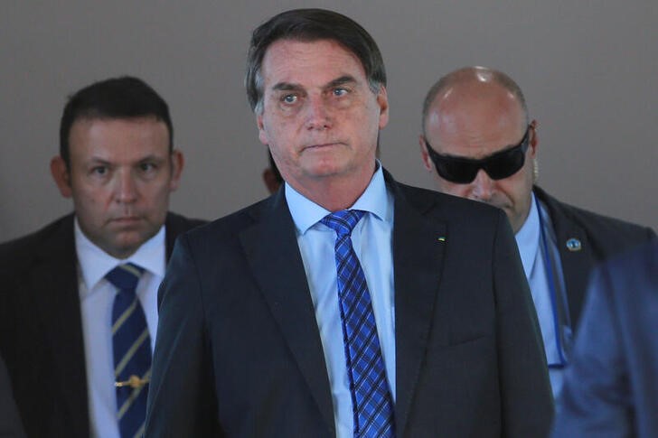 FILE PHOTO:  Brazil’s President Jair Bolsonaro walks after a