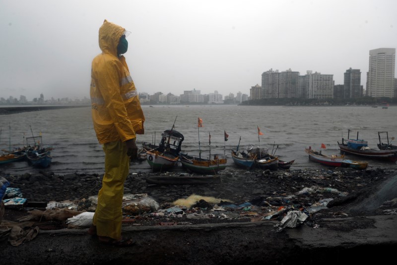 A Mumbai police official stands guard off the coast of