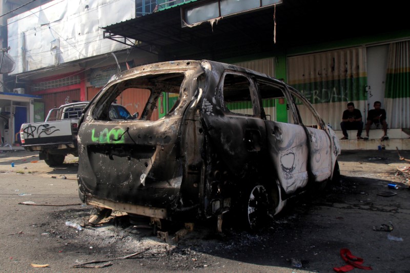FILE PHOTO:  A burnt car is pictured after a