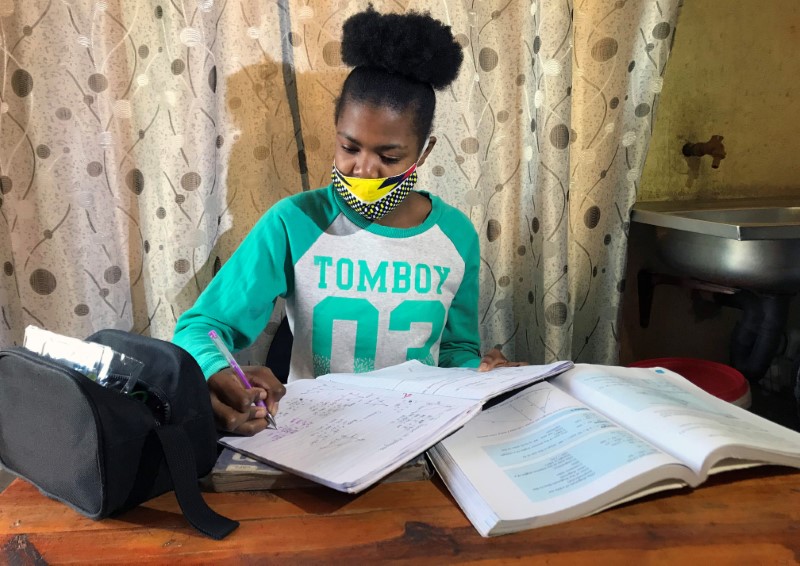 Learner Phuti Ngoetjana tries to study math at her family’s
