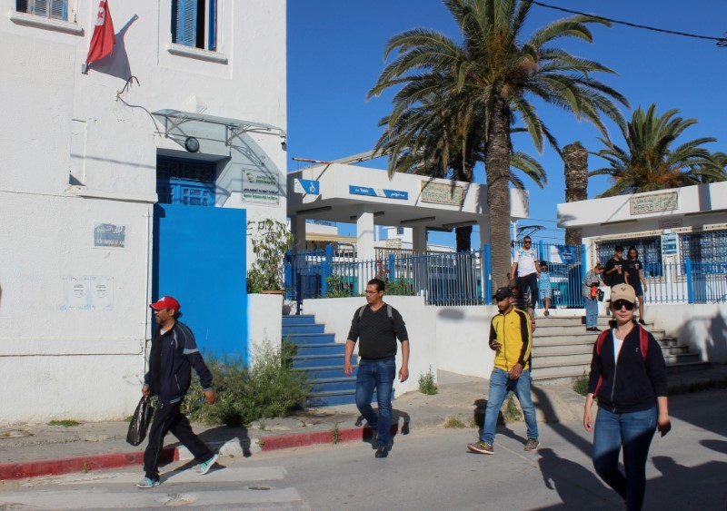FILE PHOTO: People leave a train station, as Tunisia relaxes