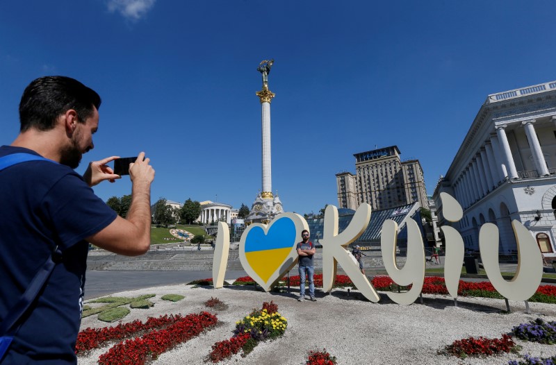 FILE PHOTO: Tourists take pictures at the Independence Square in