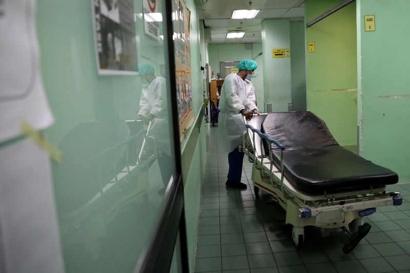 FILE PHOTO: A health worker wearing a protective suit arranges