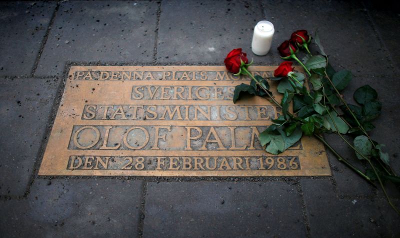FILE PHOTO: Roses are laid on a plaque marking the