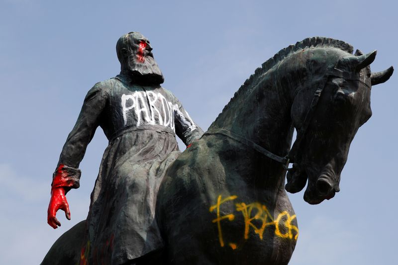 Graffitis are seen on a statue of former Belgian King