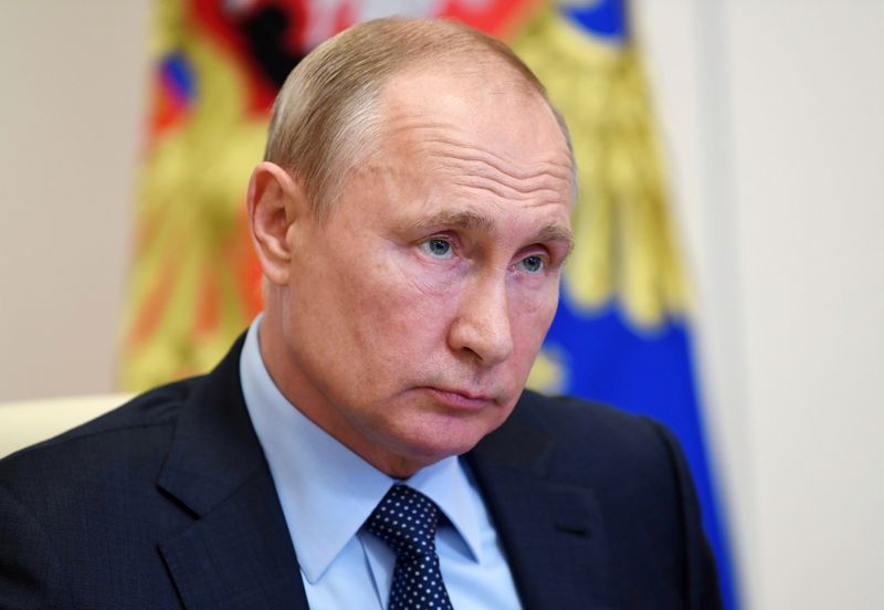 Russian President Vladimir Putin takes part in a video conference