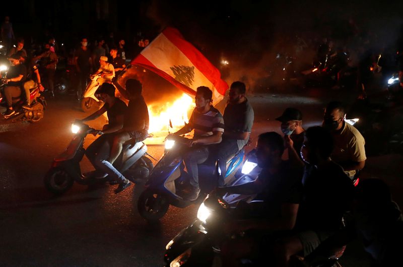 Demonstrators ride on motorbikes during a protest against fall in