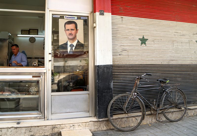 FILE PHOTO: A picture of Syrian President Bashar al-Assad is