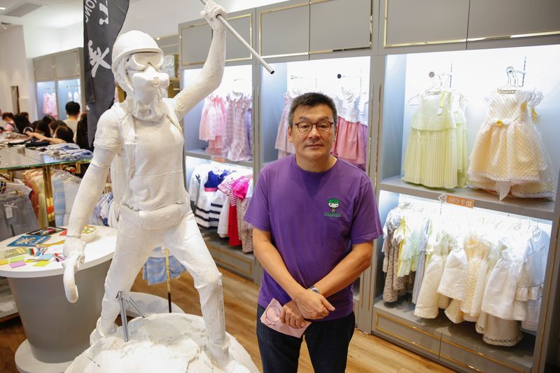Chickeeduck founder Herbert Chow poses next to the two-meter-tall “Lady