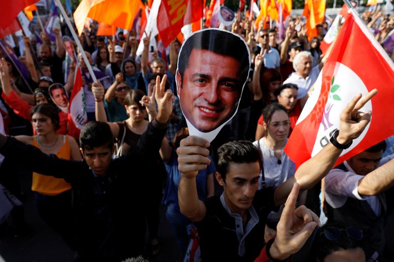 Supporters of Turkey’s main pro-Kurdish Peoples’ Democratic Party hold masks